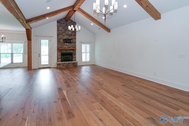 unfurnished living room featuring a chandelier, high vaulted ceiling, wood finished floors, and beam ceiling