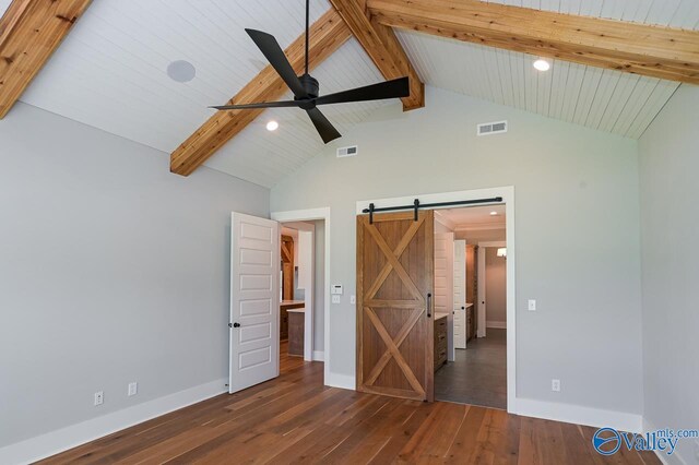 unfurnished bedroom featuring a barn door, high vaulted ceiling, hardwood / wood-style flooring, and beamed ceiling