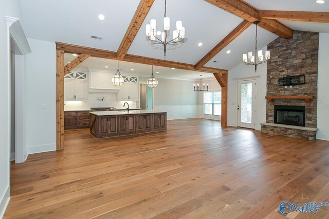 kitchen featuring a spacious island, hanging light fixtures, and light wood-type flooring