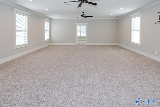 empty room with baseboards and crown molding