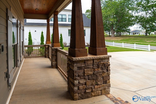 view of patio / terrace with a porch and fence