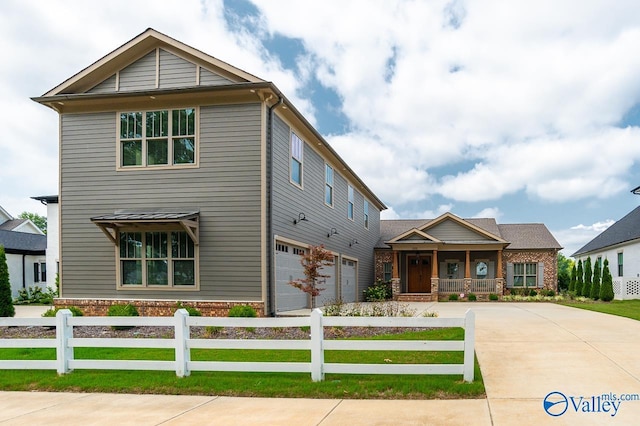 view of front of house with concrete driveway, a porch, fence, and brick siding