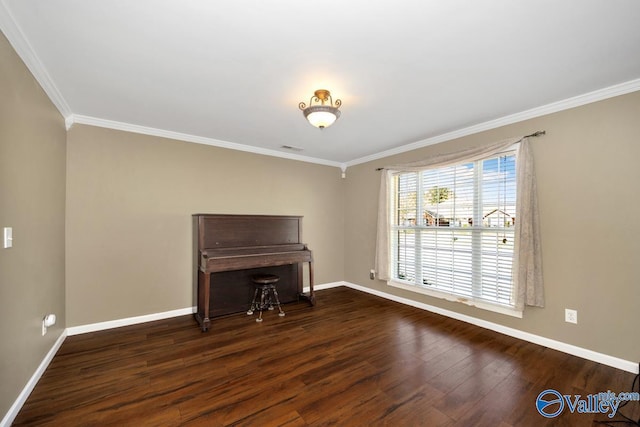 interior space with baseboards, ornamental molding, and wood finished floors