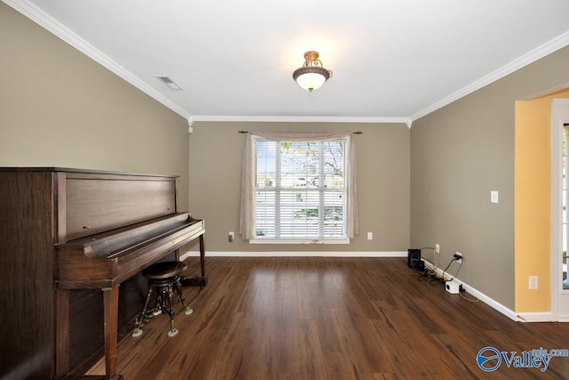 sitting room with baseboards, wood finished floors, visible vents, and crown molding