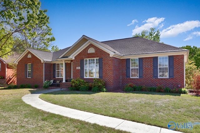 ranch-style house with brick siding and a front yard