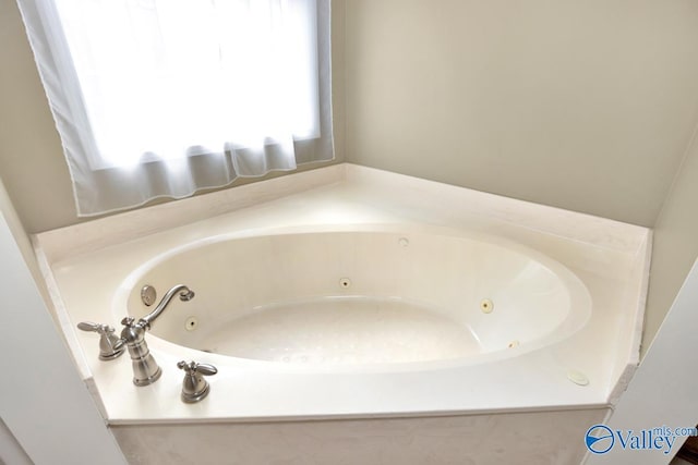 full bath with a whirlpool tub