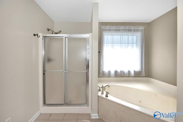 bathroom with baseboards, a garden tub, tile patterned flooring, and a stall shower