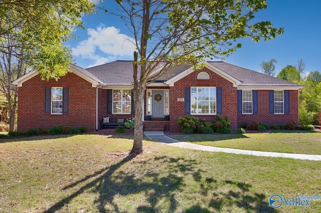 view of front of home featuring a front lawn and brick siding