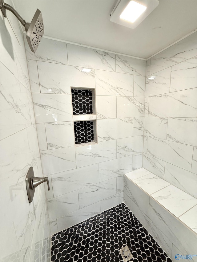 full bathroom with tiled shower