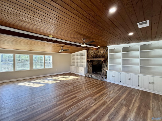 unfurnished living room with a stone fireplace, wooden ceiling, wood finished floors, and visible vents