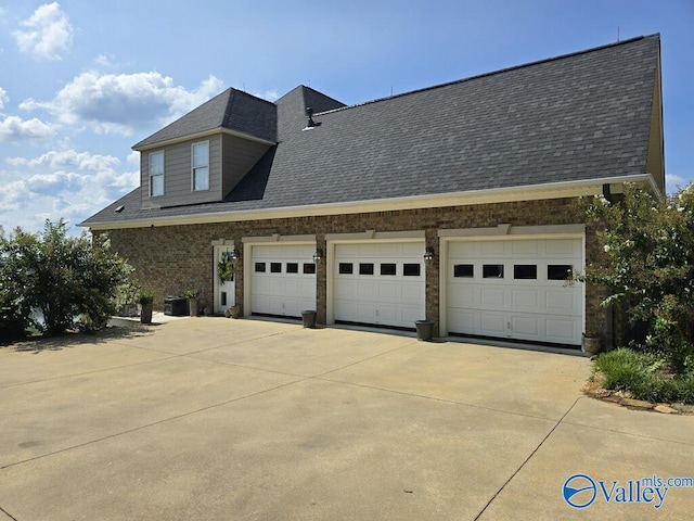 view of home's exterior featuring central AC and a garage