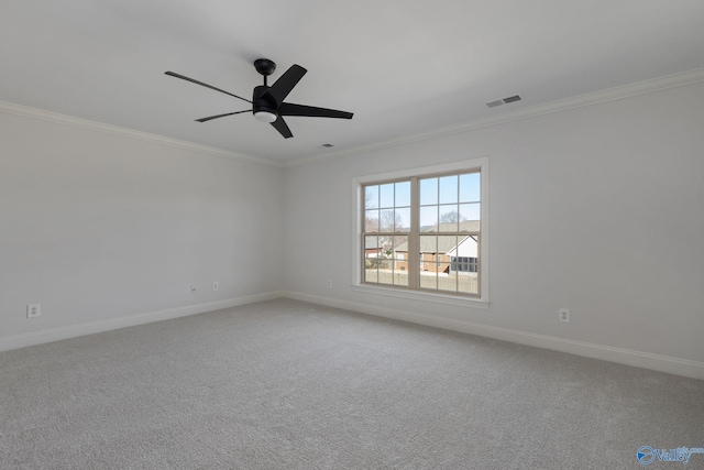 unfurnished room with visible vents, light carpet, baseboards, and crown molding