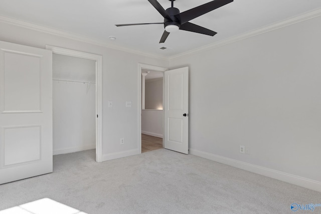 unfurnished bedroom with baseboards, carpet floors, a closet, and crown molding