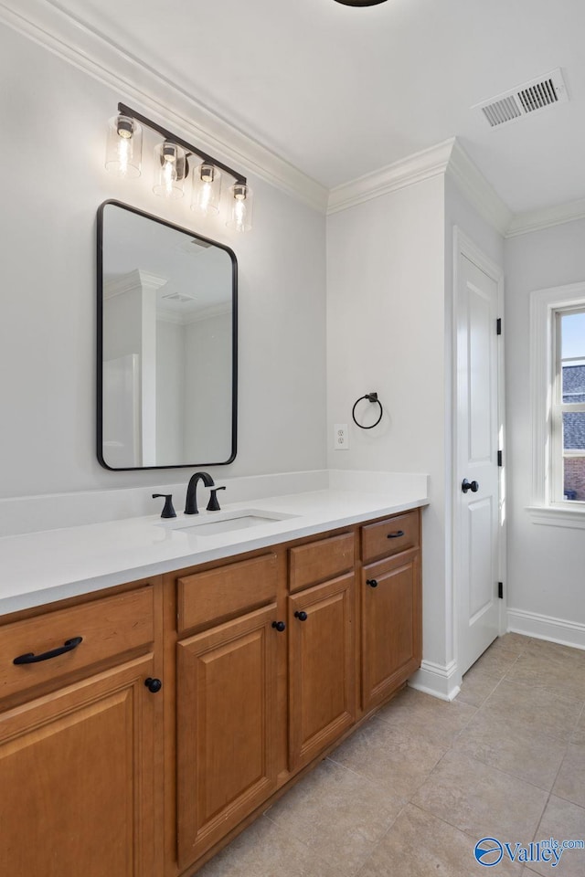 bathroom with visible vents, crown molding, tile patterned flooring, baseboards, and vanity