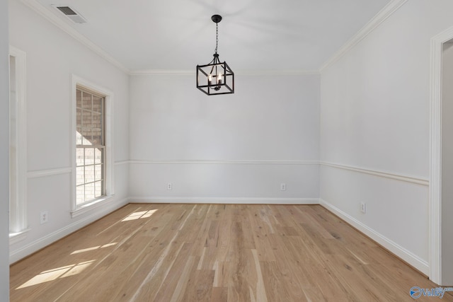 spare room with light wood-type flooring, baseboards, and crown molding