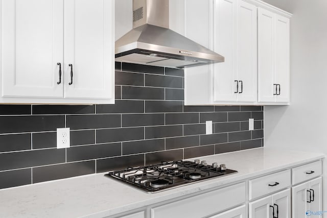 kitchen featuring white cabinetry, extractor fan, gas cooktop, and light stone counters