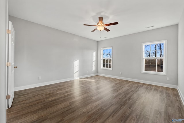 empty room with dark hardwood / wood-style floors and ceiling fan