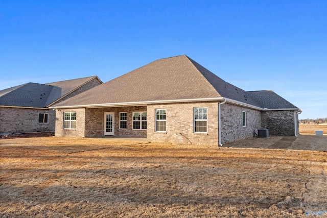 rear view of house featuring central AC unit