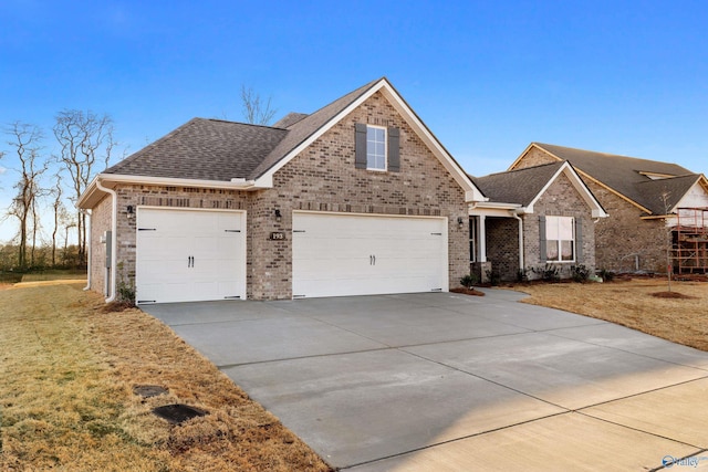 view of front of house with a garage and a front lawn