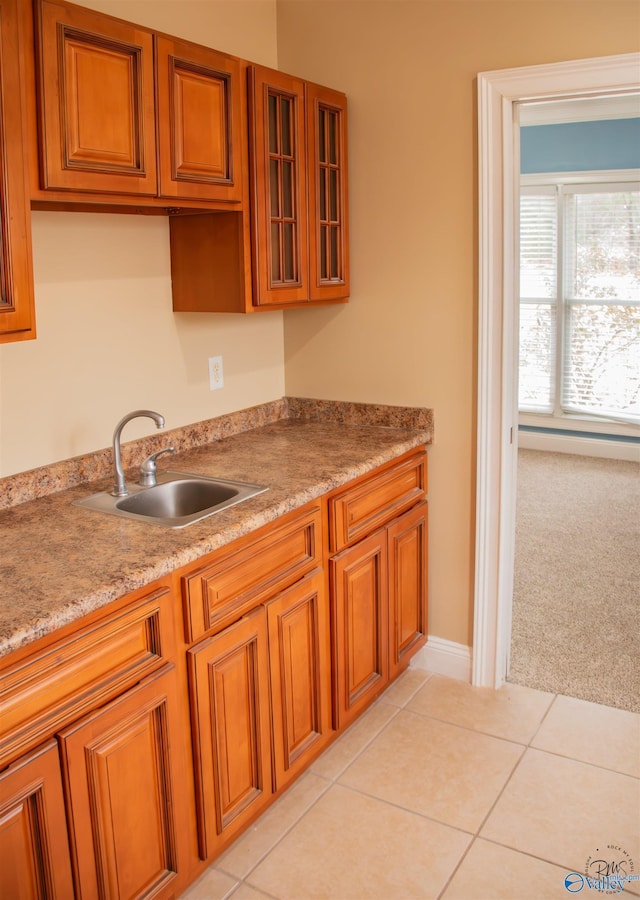 kitchen featuring light colored carpet and sink