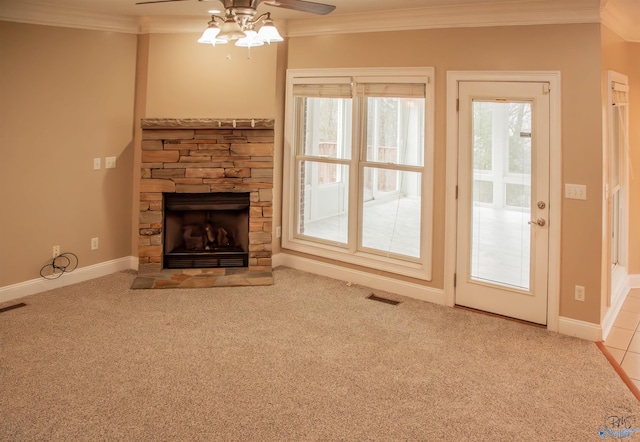 unfurnished living room with a fireplace, ceiling fan, crown molding, and light carpet