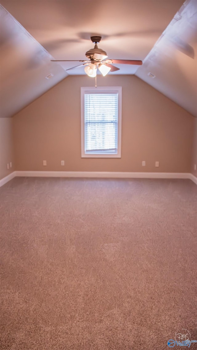 additional living space featuring ceiling fan, carpet floors, and vaulted ceiling