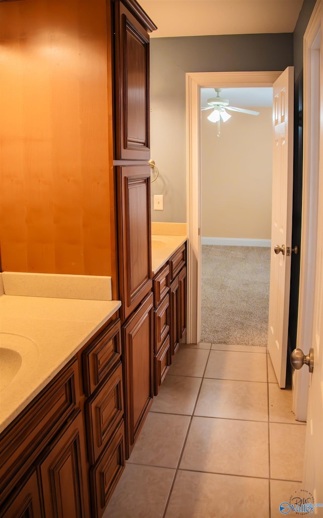 bathroom with tile patterned flooring, vanity, and ceiling fan