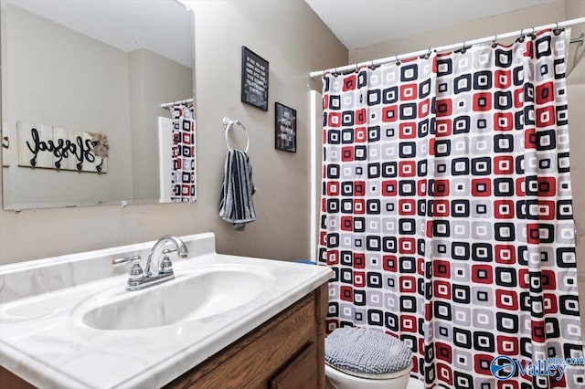 bathroom featuring vanity, toilet, and a shower with shower curtain