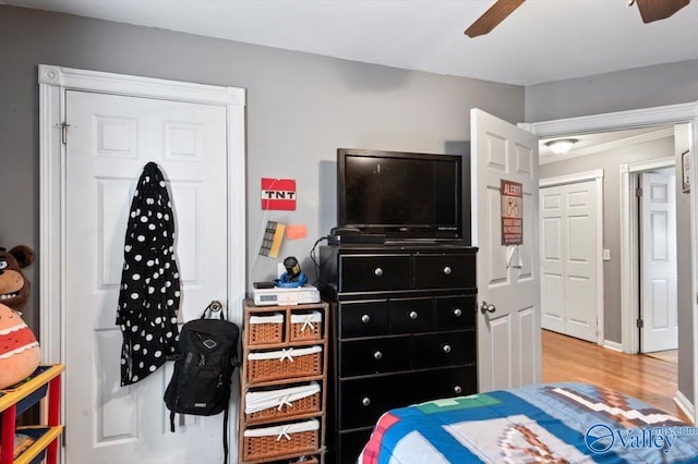 bedroom featuring ceiling fan, a closet, and light hardwood / wood-style flooring