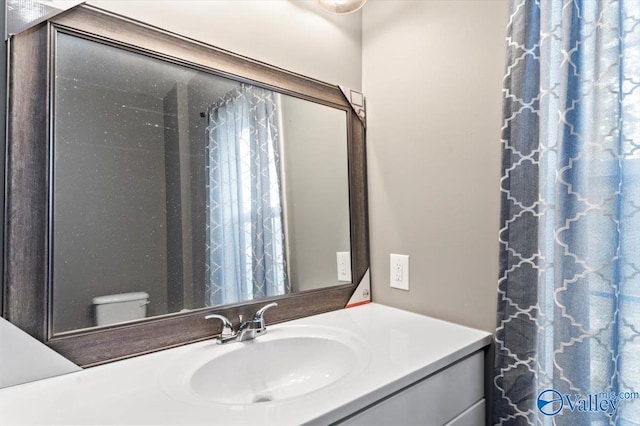 bathroom featuring toilet and vanity