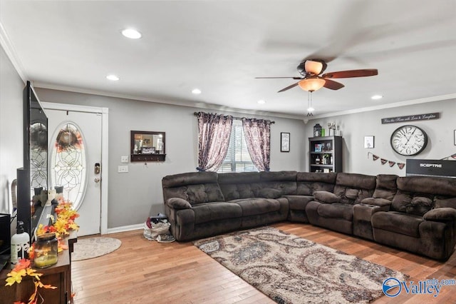 living room with light wood-type flooring, ceiling fan, and crown molding