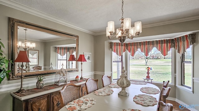 dining space with crown molding, plenty of natural light, and a notable chandelier