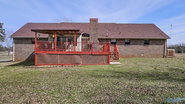 rear view of house featuring crawl space, brick siding, a lawn, and a wooden deck