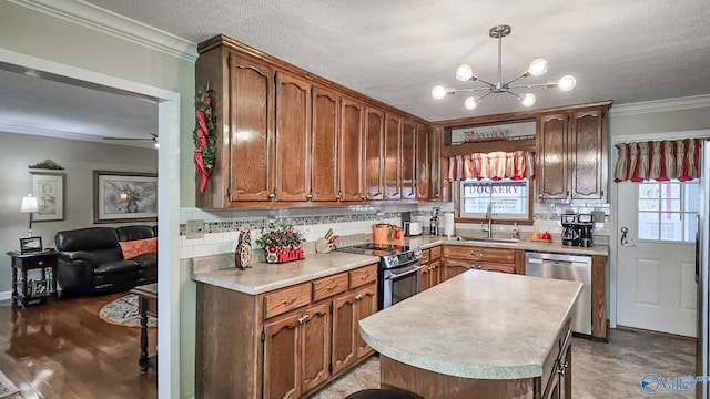 kitchen featuring a sink, a wealth of natural light, stainless steel appliances, and light countertops