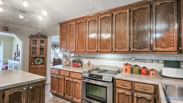 kitchen featuring tasteful backsplash, stainless steel electric range oven, ornamental molding, and light countertops