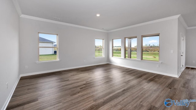 empty room with baseboards, ornamental molding, and dark wood-style flooring