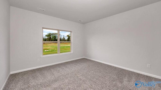 carpeted spare room with baseboards and visible vents