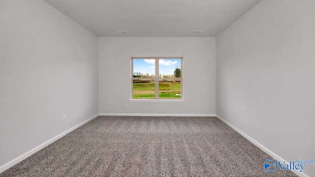 carpeted empty room with baseboards and visible vents