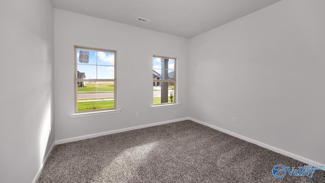 carpeted empty room with baseboards and visible vents