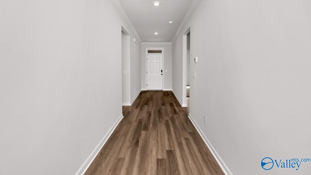 hallway featuring dark wood-style floors, crown molding, baseboards, and recessed lighting