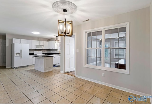 26560 Mill Creek Dr, Athens, AL 35613 - kitchen featuring a chandelier, white cabinetry, dark countertops, white appliances, and visible vents