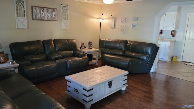 living room with crown molding, dark hardwood / wood-style floors, and ceiling fan