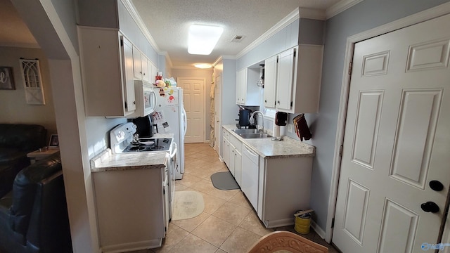 kitchen featuring sink, white cabinets, white appliances, light tile patterned floors, and ornamental molding