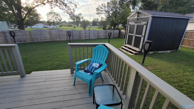 wooden terrace featuring a storage unit and a lawn