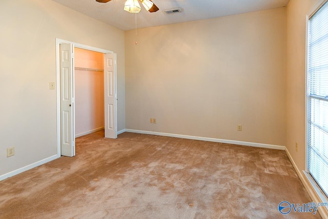 unfurnished bedroom with ceiling fan, carpet, visible vents, and baseboards