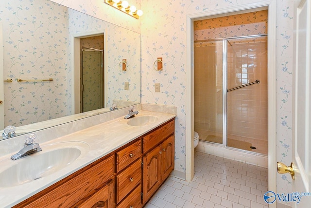 full bathroom with wallpapered walls, tile patterned flooring, and a sink