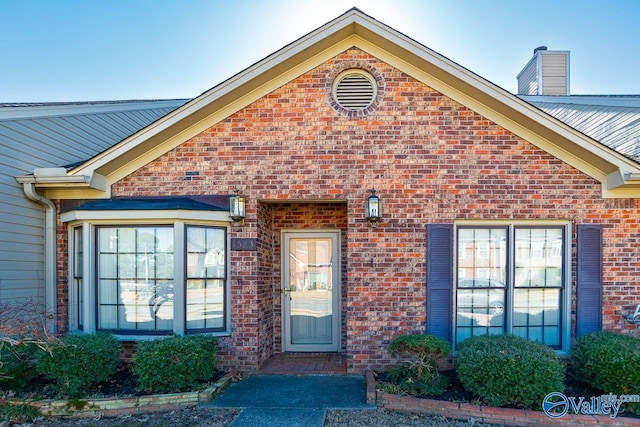 doorway to property with brick siding