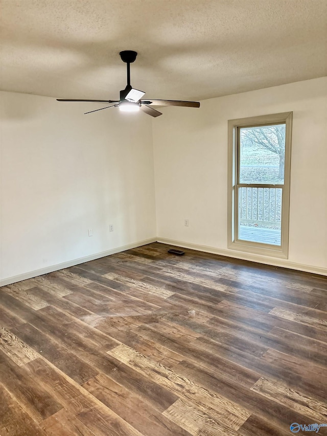 unfurnished room with a textured ceiling, ceiling fan, and dark wood-type flooring