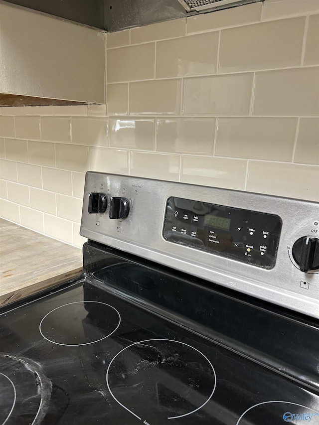 room details featuring backsplash and stainless steel range oven