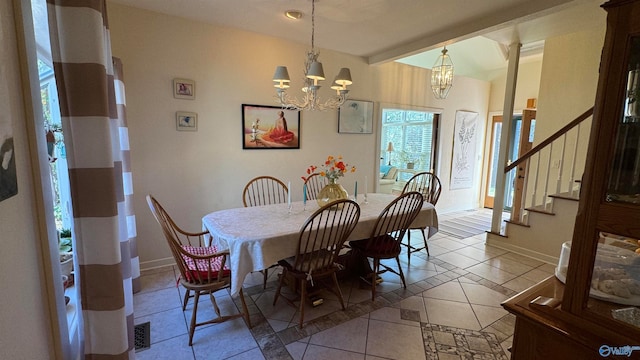 dining area with tile patterned flooring and an inviting chandelier